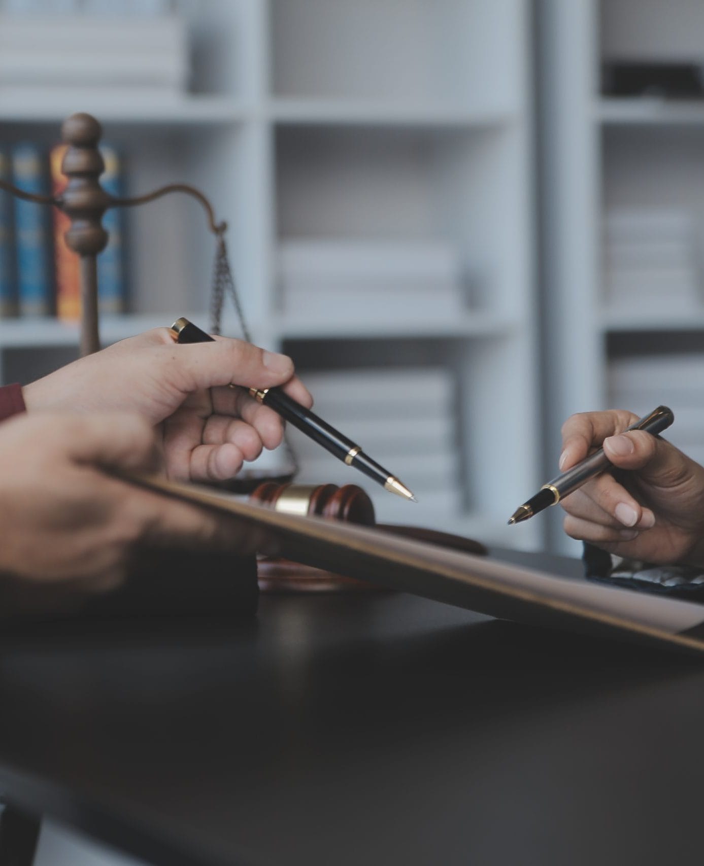 business lawyers discussing contract papers with brass scale desk office law legal services advice justice law concept picture with film grain effect scaled e1753885577410